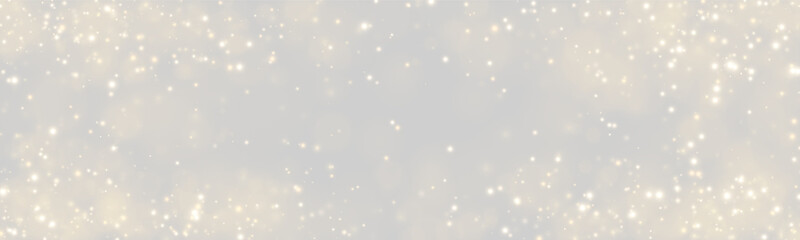 Fototapeta premium Gleaming golden particles create a sparkling bokeh effect across a dark background. The light dots vary in size and intensity, creating a sense of depth and softness.