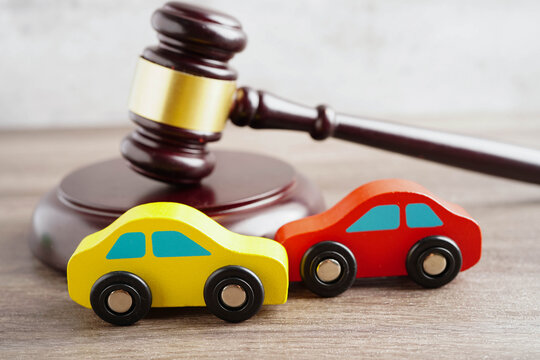 Car accident lawsuit and insurance, Judge hammer with car model.