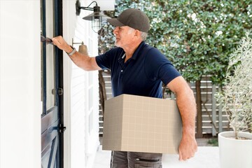 Delivery man holding package at front door during home delivery