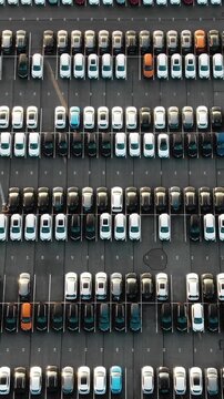 Giant outdoor parking lot with countless new cars perfectly aligned in rows, a powerful visual for automotive industry logistics, global trade, import export business, and mass production