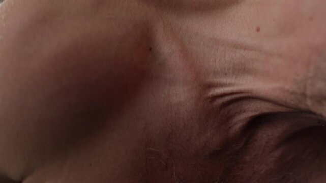 Muscular Caucasian adult man straining neck and chest muscles during heavy gym workout. Footage ideal for fitness branding, athletic training content, and sports nutrition ads