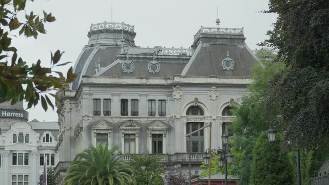 Ornate historical architecture of a white government palace. Majestic facade with intricate details surrounded by lush green trees