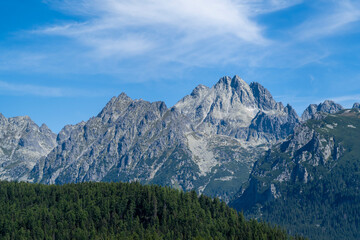 A landscape of mountains and forests covering the slopes and valleys. © gubernat