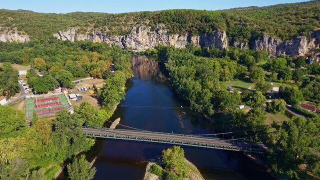 Dordogne River passes beneath Pont de Meyronne on the D15 between Saint-Sozy and Meyronne, Lot, Occitanie, France, with Quercy limestone cliffs and riverside recreation areas, DFF