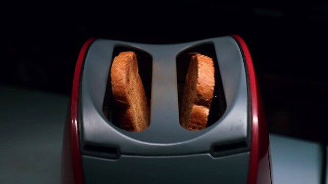 Toaster Toasting Bread
Close up of a toaster browning fresh bread for breakfast and in slow motion