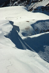 Snow cornices along the snow-covered ridge of the Alpine peaks Pizzo Baciamorti and Monte Araralta. Orobie Alps, Italy. © Gherzak