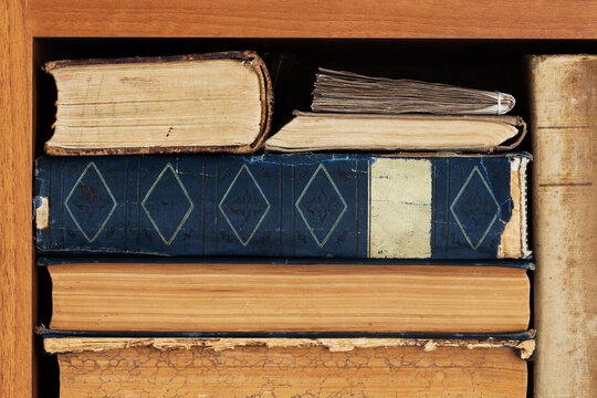 Antique books with yellow pages and worn retro spines on wooden shelf. Vintage reading flyer, library leaflet, knowledge card