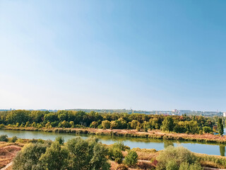 Obraz premium Same natural landscape with river and trees changing during different seasons close up. Concept of seasonal changes, nature progression, climate cycle, countryside view, and outdoor environment.