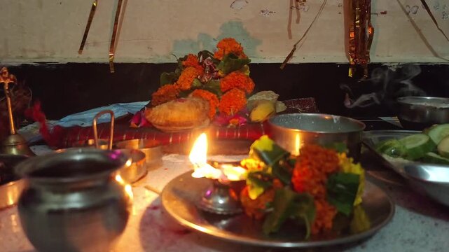 Hindu Puja Altar with Marigold Flowers, Diya Lamp and Traditional Offerings