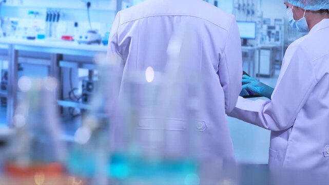 Lab work, scientists holds a test tube takes the test from a test tube in analysis for vaccine development.