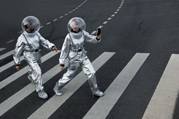 Graphic composition with silver astronauts and white stripes of a crosswalk, geometry and lines © Ulia Koltyrina