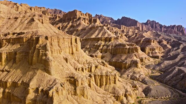 Aerial view of dramatic arid canyons and sandstone cliff formations in the Red Mountain Stone Forest, Kuqa, Xinjiang, China
