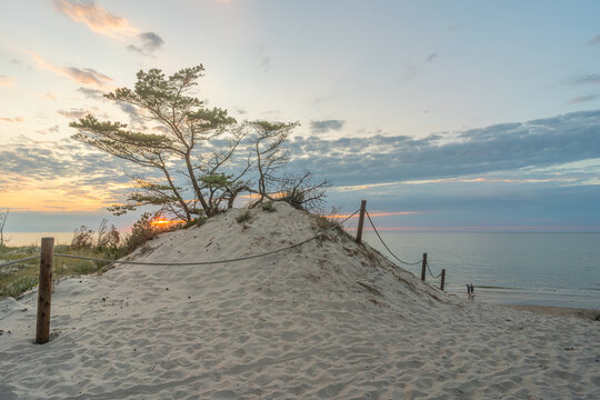 Sunset over the Baltic Sea from the sandy beach in Słowiński National Park near Rowy, Poland