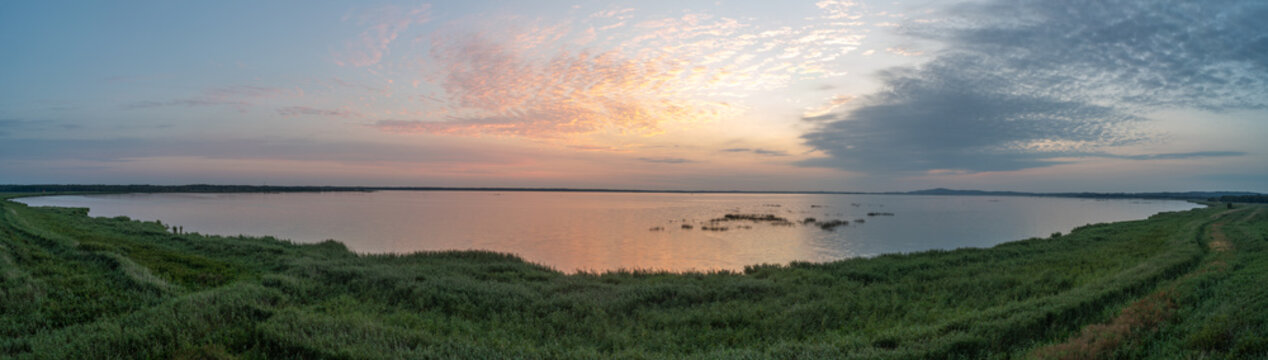 Panoramic sunrise view over Lake Gardno and coastal landscape from a lookout tower in Słowiński National Park