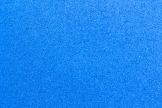 blue paper background texture light rough textured spotted blank copy space background in blue