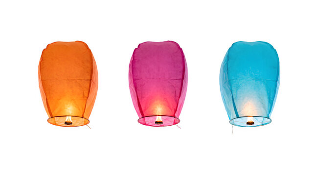 Three colorful sky lanterns in orange pink and blue colors isolated on a white background
