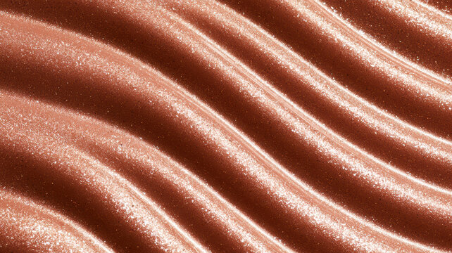 Rose gold glitter shimmering on a wavy textured surface, creating an elegant abstract background for luxury cosmetics, fashion, and festive design concepts
