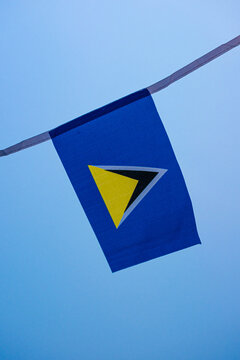Saint Lucia national flag waving in the wind, representing Saint Lucia Independence Day, Caribbean identity and national pride. Blue flag with distinctive black, white and gold triangles, suitable for