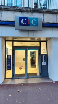 Royan, France - July 15, 2026: Charente-Maritime. Nouvelle-Aquitaine. CIC bank entrance with glass doors, blue and white signage, and modern architecture in urban setting