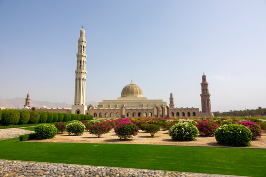 Wide view of the Sultan Qaboos Grand Mosque with its golden dome and minarets surrounded by gardens, Governorate of Muscat, Muscat, Oman