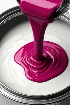 Bright pink liquid paint pours into white base paint in metal. Thick viscous pigment stream creates custom color shade for home renovation. Close up view of mixing colorful tint for interior wall