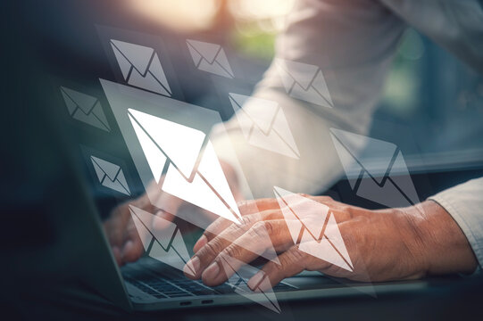Email Marketing and Direct Communication Concept with Businessman Typing on Laptop.
