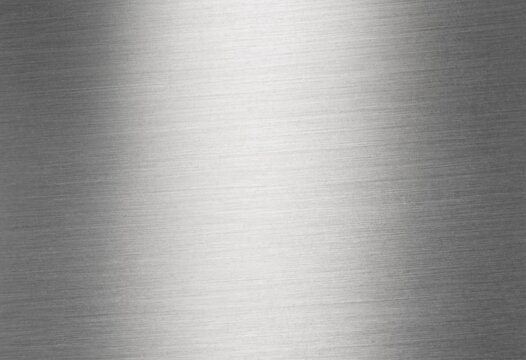 Brushed stainless steel metal texture with fine linear hairline patterns, reflective silver highlights, dark edges, and modern industrial styling for technology backgrounds.
