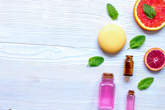 organic cosmetic with citrus on wooden background top view