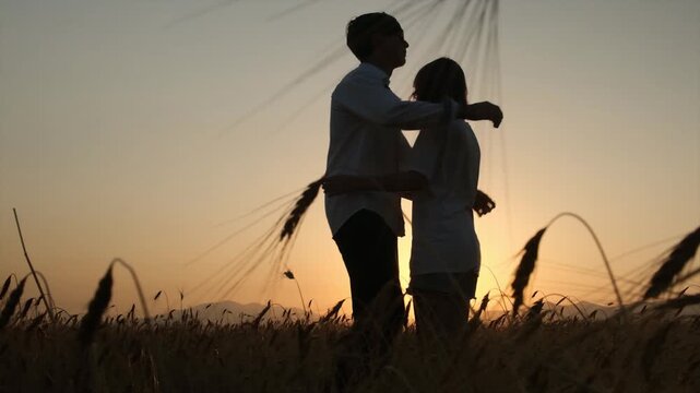 A tall young boy and shorter girl walk toward each other and embrace warmly, staying close after a long separation. First love, reunion after separation, youthful happiness, tender moments.