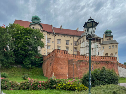 Krakow, Poland, July 26, 2025: Wawel Royal Castle in Krakow, Poland, and electric tourist vehicles (melex)