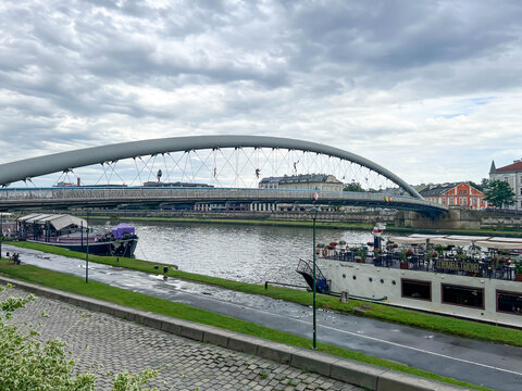 Krakow, Poland, July 26, 2025: The Father Bernatek Footbridge in Krakow, Poland, a popular pedestrian and bicycle crossing over the Vistula River, connects the districts of Kazimierz and Podgorze
