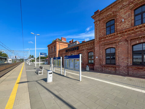 Myszkow, Poland, July 26, 2025: The railway station building in Myszkow, Poland, seen from the platforms. The red brick building is unplastered