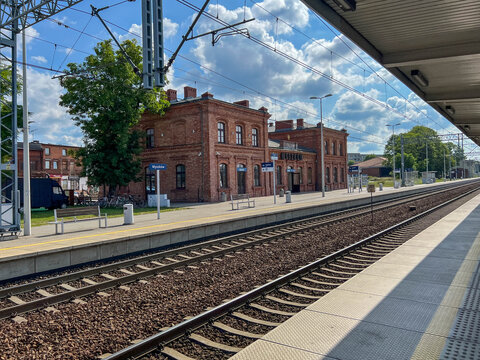 Muszkow, Poland, July 26, 2025: The railway station building in Myszkow, Poland, seen from the platforms. The red brick building is unplastered