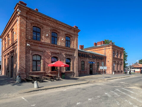 Myszkow, Poland, July 26, 2025: The railway station building in Myszkow. The red brick building is unplastered