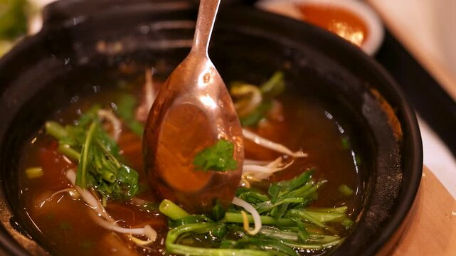 Traditional Thai Beef Noodle Soup Served in Clay Pot