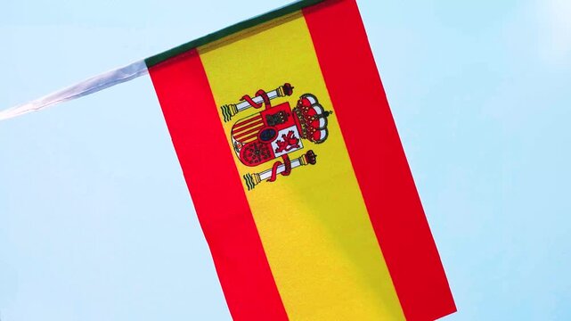 Spanish national flag waving in the wind, representing Spain&rsquo;s National Day, Fiesta Nacional de Espa&ntilde;a, national pride and Spanish identity. Red and yellow Rojigualda flag suitable for patriotic celeb