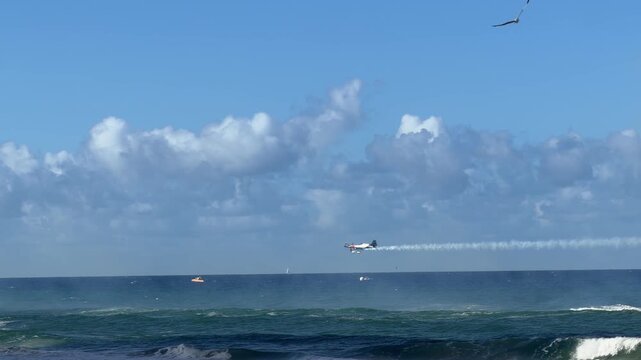 Stunt Plane Flying Low Over Ocean at Surfers Paradise