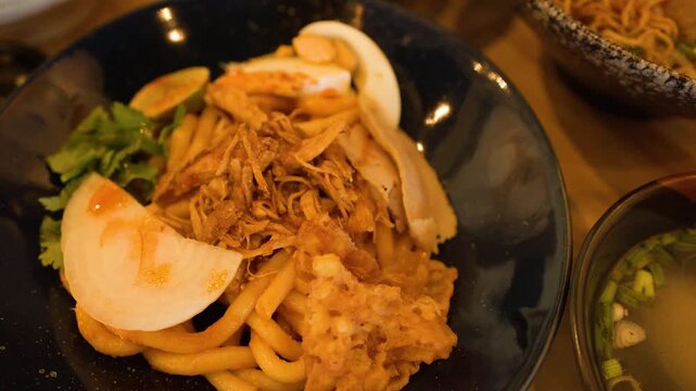 Burmese Nan Gyi Thoke Noodle Salad Dish with Boiled Egg and Crispy Fritters