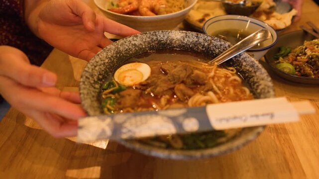Serving a Bowl of Traditional Burmese Beef Mee Shay Noodles