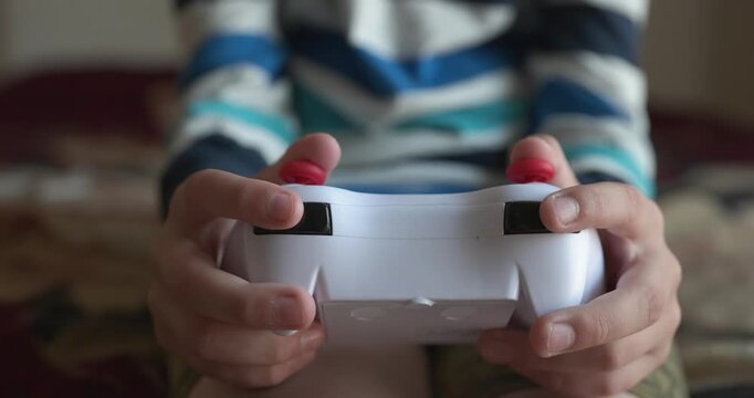 Caucasian kid hands use joystick remote controller. Boy play video game. 4K 10-bit