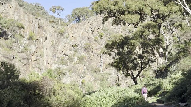 A girl walks through the powerful canyon along the Werribee Gorge Circuit Walk, in Werribee Gorge State Park, near Melbourne, Victoria, Australia.