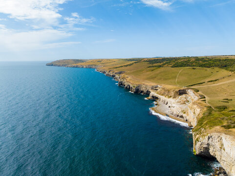 Aerial shot of the Jurassic Coastline of Dorset and the Dancing Ledge with cliffs and caves on summer day