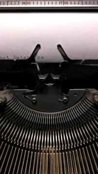 Vertical Close Up of Vintage Typewriter Typing "Selamat Datang ke Dunia" in Indonesian
