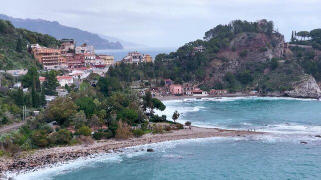 Scenic coastline view of Isola Bella and Taormina bay with turquoise sea in Sicily Italy