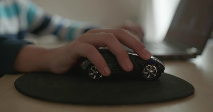 Close-up caucasian children hand use computer mouse controller. Boy use laptop. 4K 10-bit