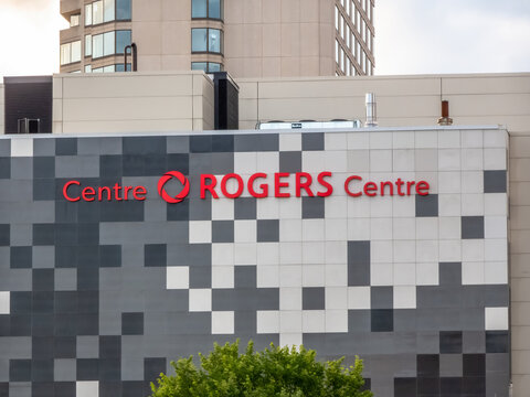 Ottawa, Ontario, Canada. Sep 10, 2026. Exterior view of Rogers Centre Ottawa signage mounted on tiled building facade with trees below.