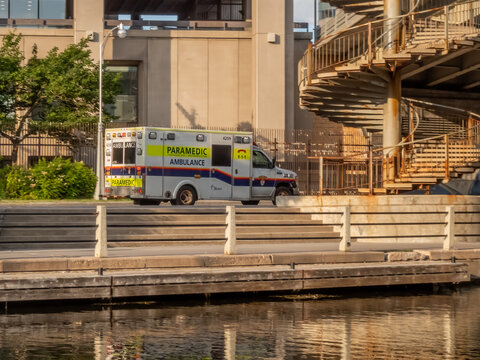OTTAWA, ONTARIO, CANADA. SEPTEMBER 10, 2026. Ottawa Paramedic Service ambulance parked along a canal waterfront in bright sunlight.