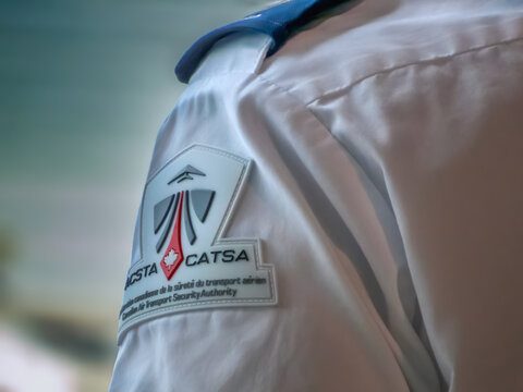 Ottawa, Ontario, Canada. Sep 10, 2026. Close-up of CATSA security screening officer shoulder patch emblem on white uniform shirt at airport.