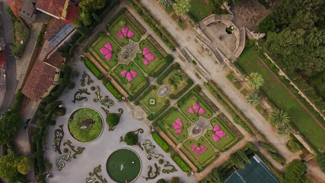An enchanting aerial rotating perspective reveals the magnificent Garzoni Historic Garden in Collodi, showcasing its stunning Baroque design and vibrant patterns.