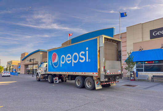 CALGARY, AB, CANADA - SEP 10, 2026: Low-angle view of a Pepsi delivery truck parked outside a Sage Hill shopping center for supply distribution.